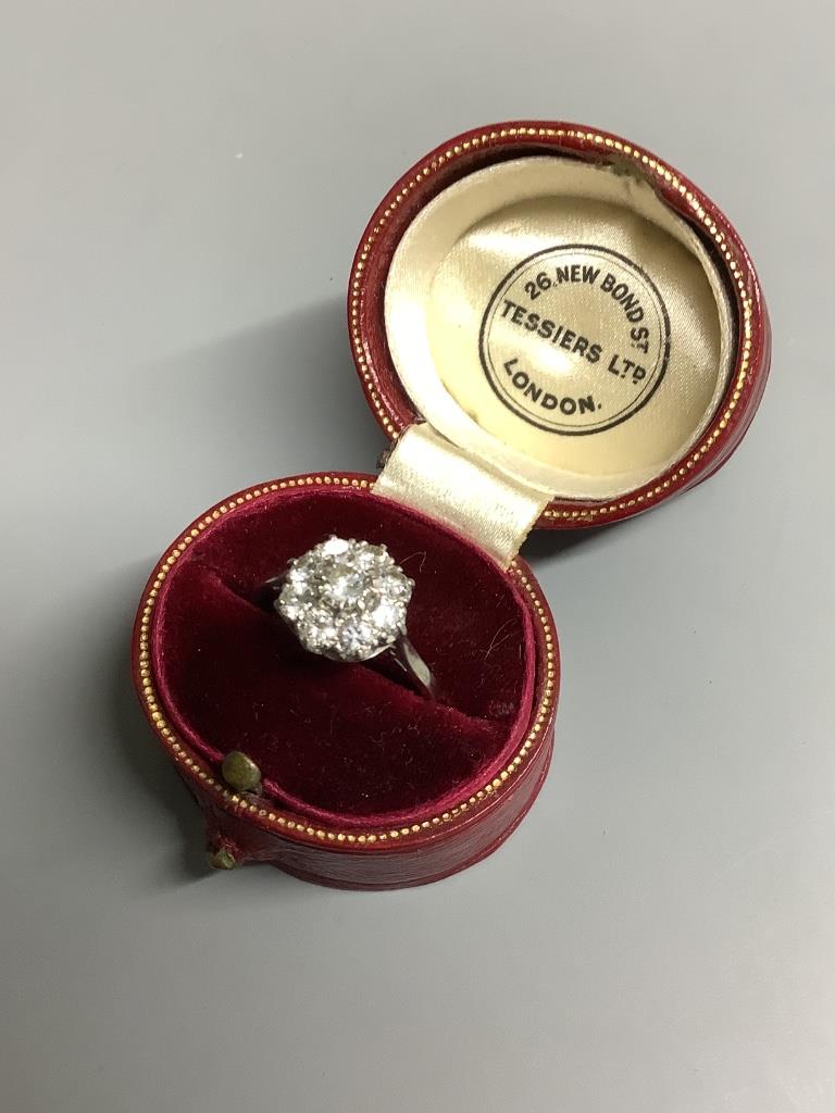 A platinum and nine stone diamond circular cluster ring